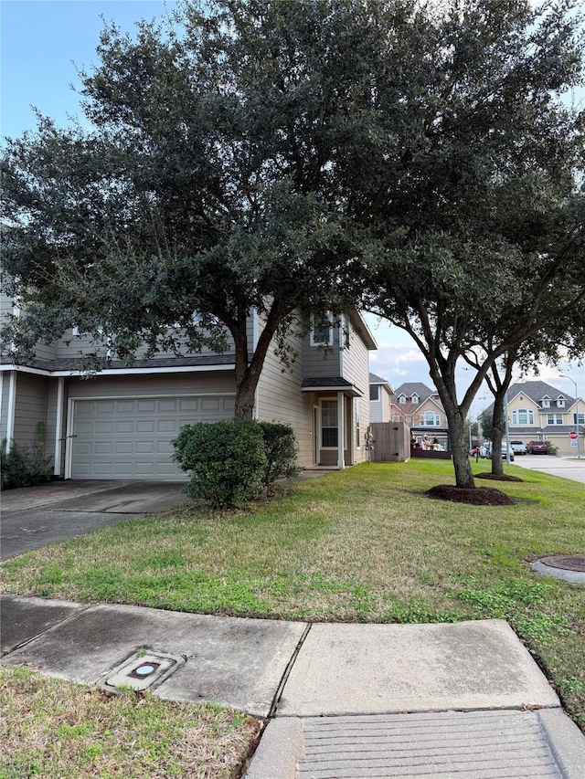 view of front of property featuring a garage and a front lawn