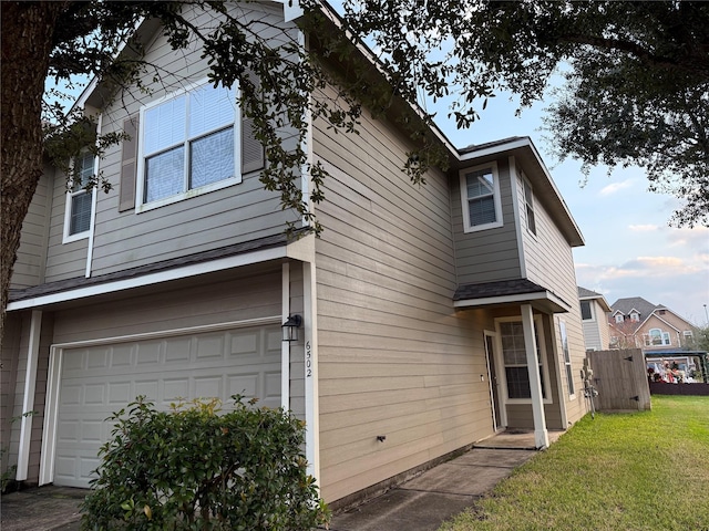 exterior space with a yard and a garage