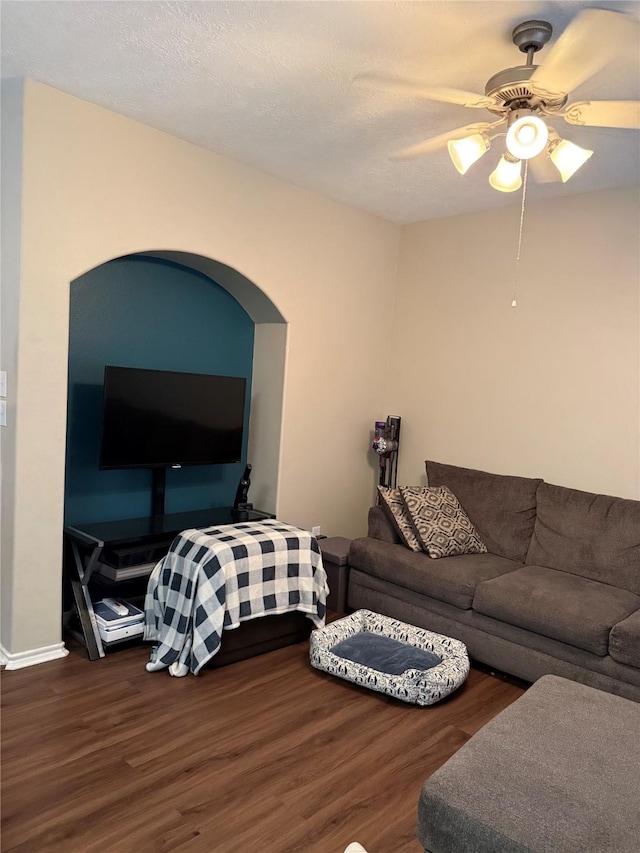 living room featuring ceiling fan and wood-type flooring