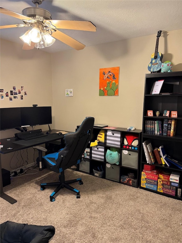 carpeted office featuring a textured ceiling and ceiling fan