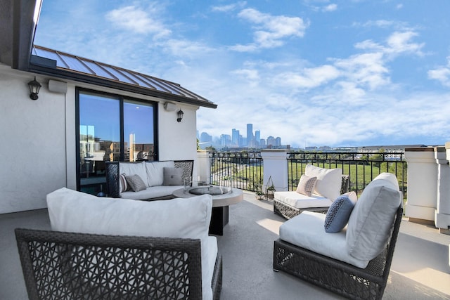 view of patio with outdoor lounge area and a balcony