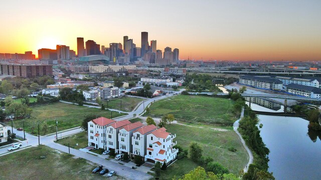 aerial view at dusk featuring a water view