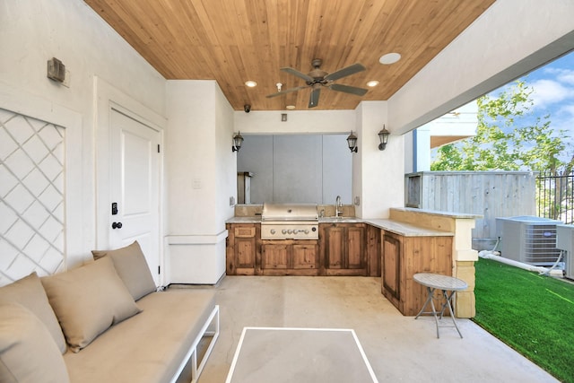 view of patio / terrace featuring ceiling fan, sink, a grill, cooling unit, and area for grilling