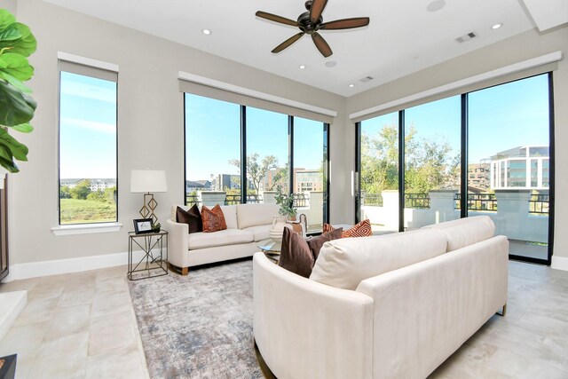 living room with ceiling fan and plenty of natural light