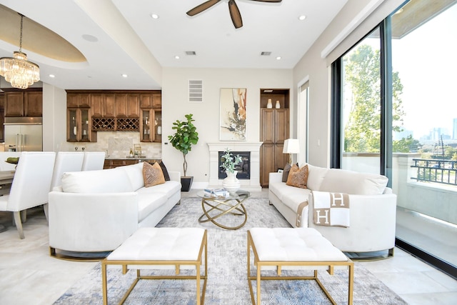 living room with ceiling fan with notable chandelier