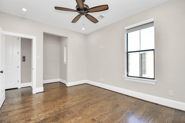 empty room featuring ceiling fan and dark hardwood / wood-style flooring