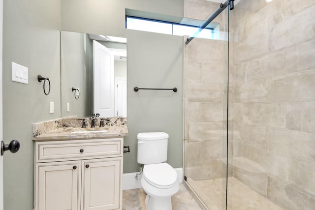 bathroom featuring vanity, toilet, and walk in shower