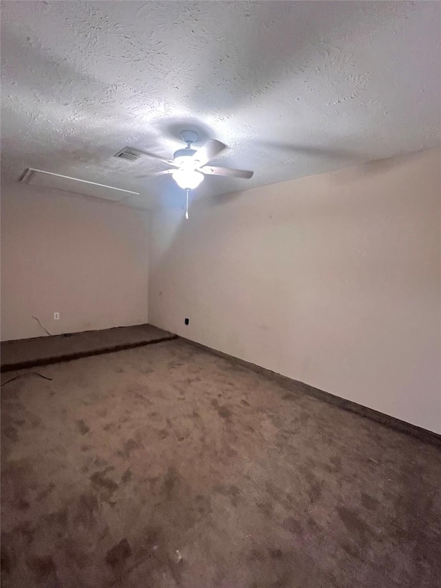 carpeted empty room featuring a textured ceiling