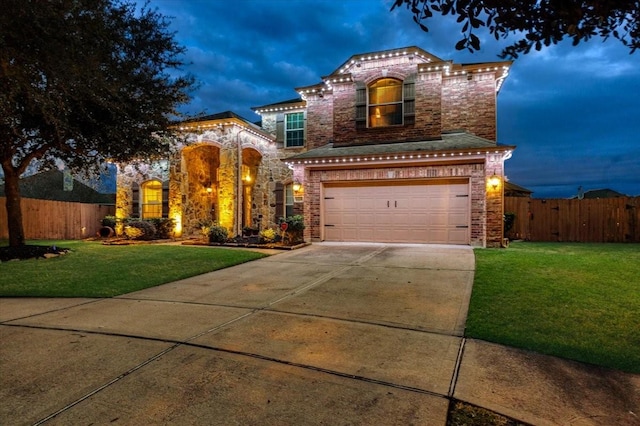 view of front of house with a garage and a yard