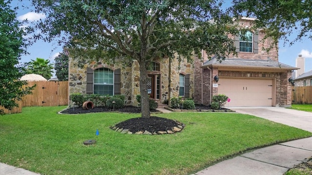 view of front of house with a front yard and a garage