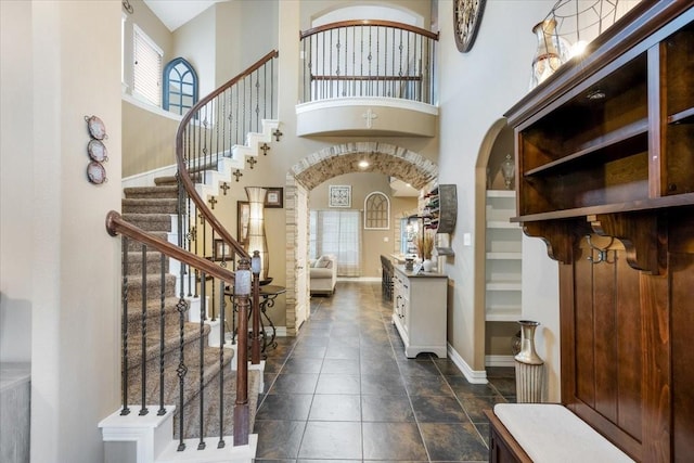 foyer entrance with a towering ceiling