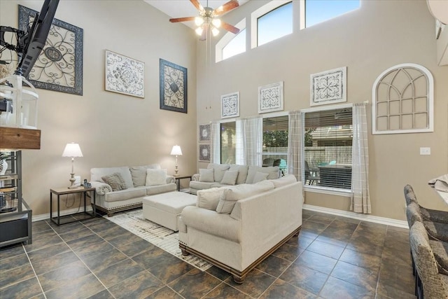 living room featuring a high ceiling and ceiling fan