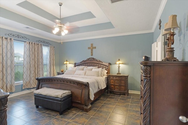 bedroom with a tray ceiling, ceiling fan, and crown molding