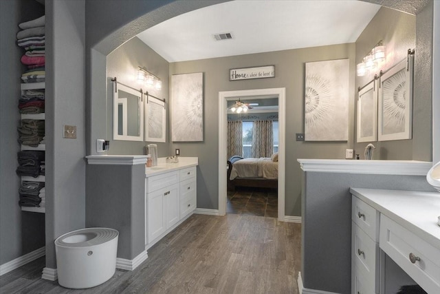 bathroom featuring hardwood / wood-style floors, vanity, and ceiling fan