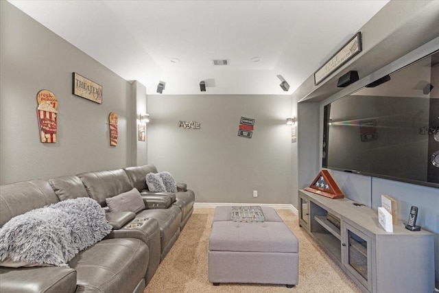 home theater room featuring light colored carpet and lofted ceiling