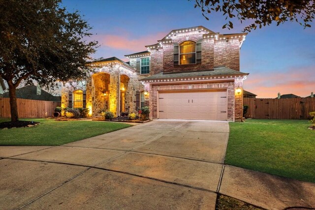 view of front of property featuring a yard and a garage