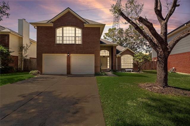 view of front property with a garage and a lawn