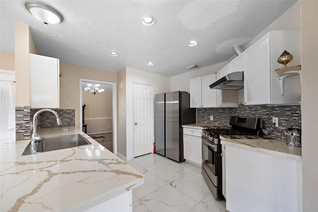 kitchen featuring white cabinets, sink, range hood, appliances with stainless steel finishes, and light stone counters