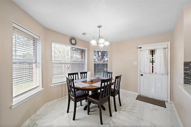 dining area with a notable chandelier