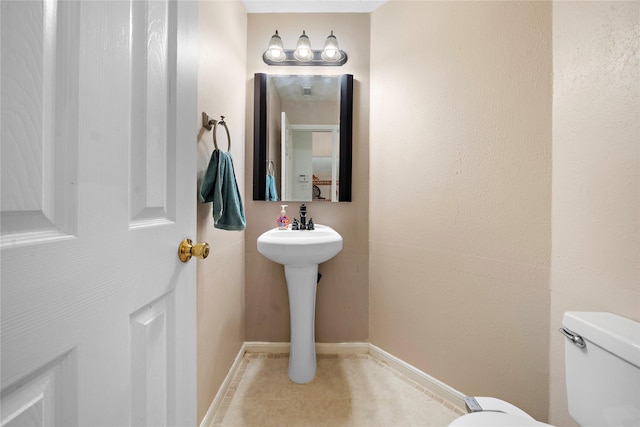 bathroom featuring tile patterned floors and toilet