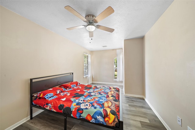 bedroom featuring hardwood / wood-style flooring and ceiling fan