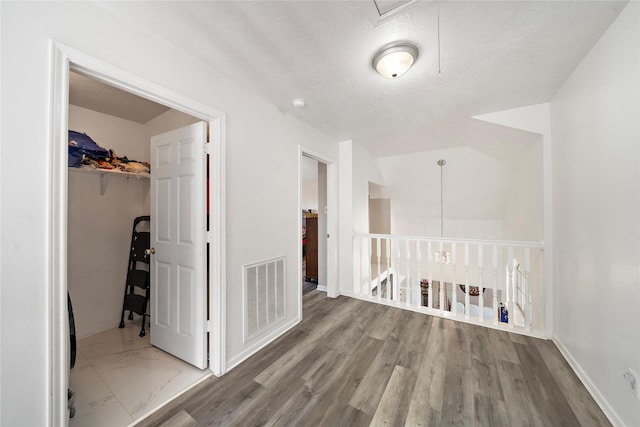 clothes washing area with a textured ceiling