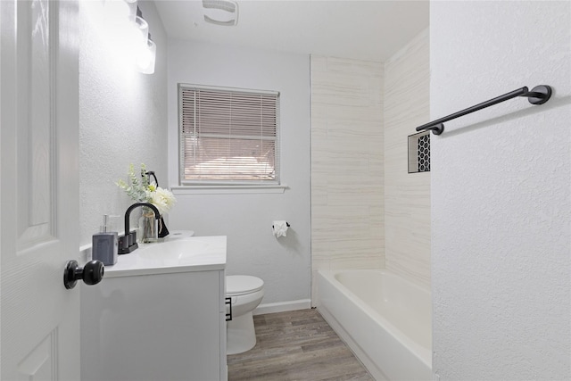 full bathroom featuring hardwood / wood-style floors, vanity, toilet, and shower / tub combination