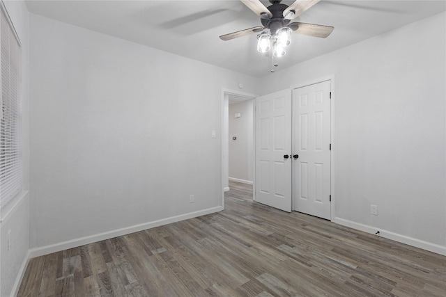 empty room with wood-type flooring and ceiling fan