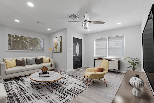 living room featuring ceiling fan and light wood-type flooring