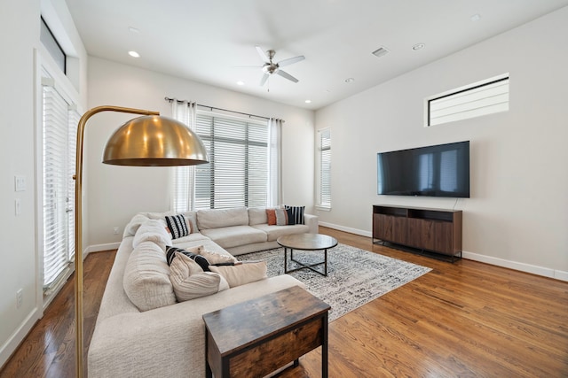 living room featuring ceiling fan and hardwood / wood-style flooring