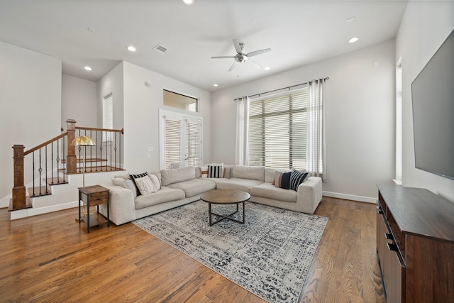 living room with wood-type flooring and ceiling fan