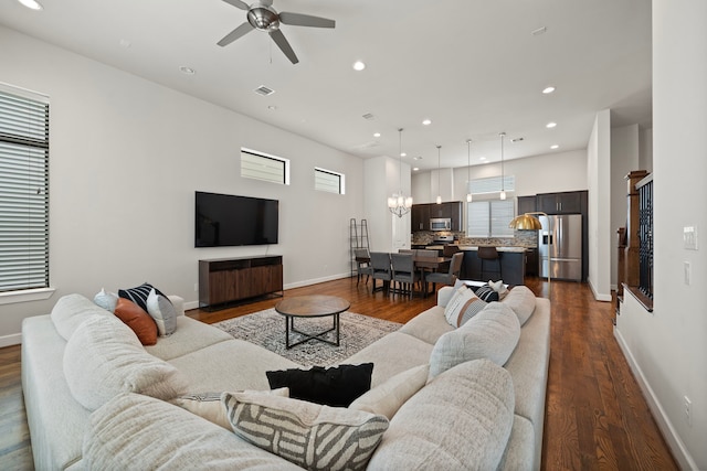 living room featuring ceiling fan and dark hardwood / wood-style floors