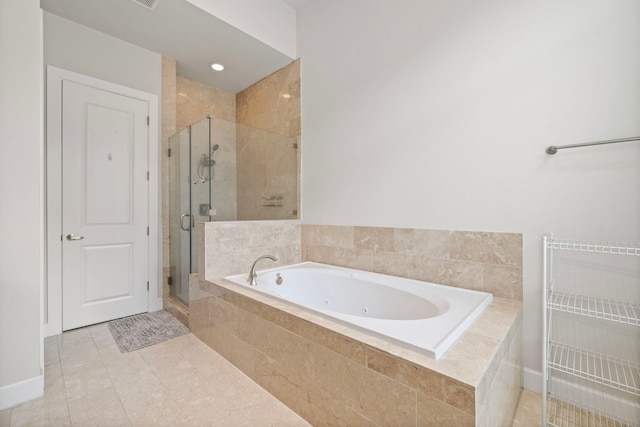 bathroom with tile patterned flooring and separate shower and tub