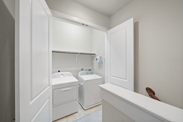 washroom featuring light tile patterned floors and washer and clothes dryer