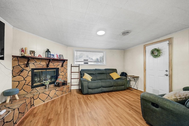 living room with hardwood / wood-style flooring and a fireplace