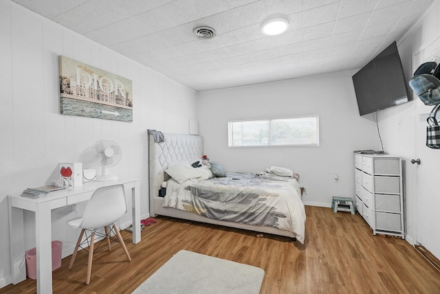 bedroom with hardwood / wood-style flooring