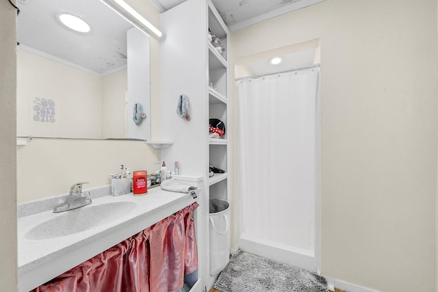 bathroom featuring vanity and ornamental molding