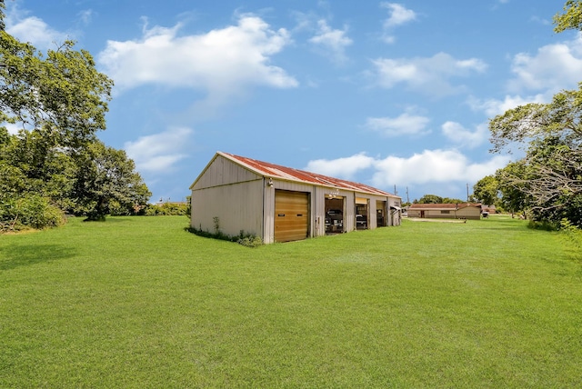 view of yard featuring an outbuilding and a garage