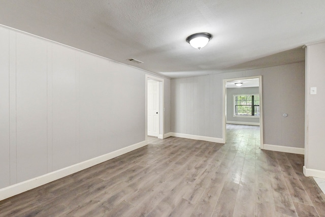 unfurnished room with light wood-type flooring