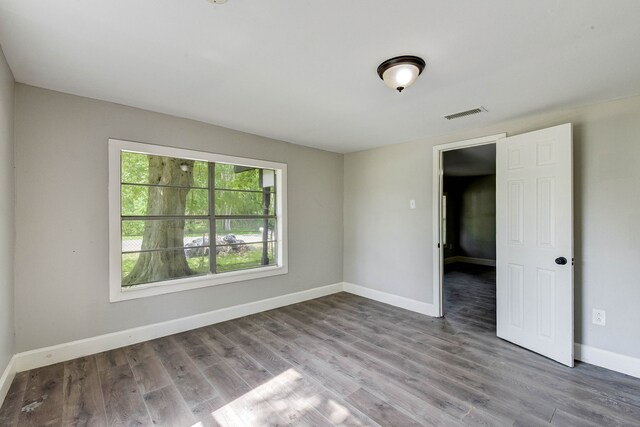 spare room featuring wood-type flooring