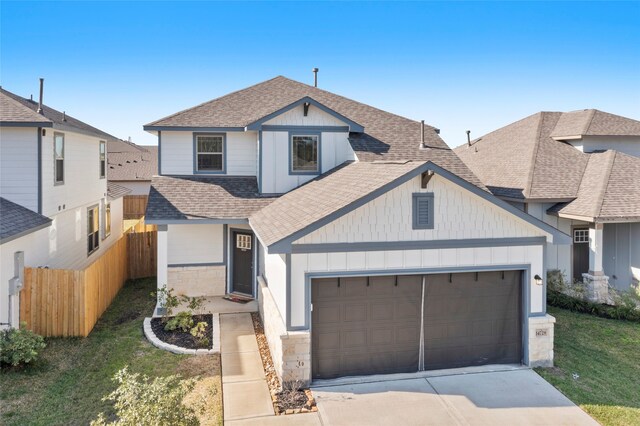 view of front of home with a front lawn and a garage