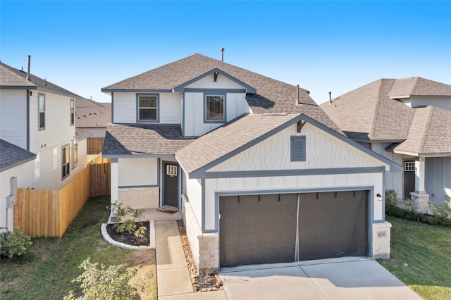 view of front facade with board and batten siding, fence, roof with shingles, a garage, and driveway