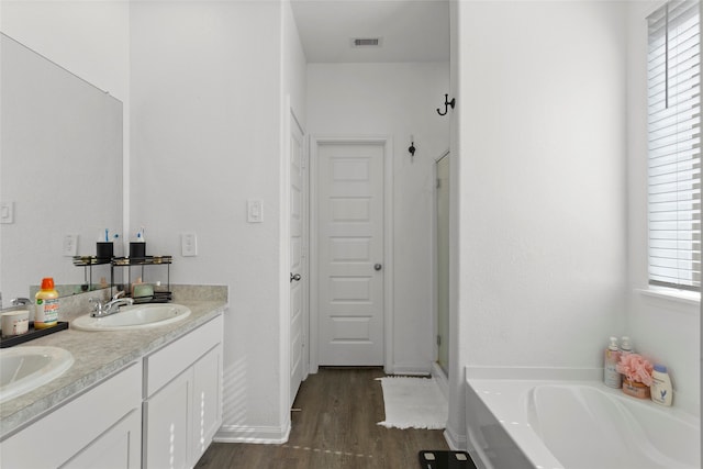 bathroom featuring separate shower and tub, hardwood / wood-style floors, and vanity