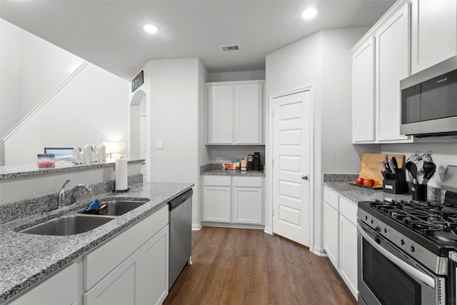 kitchen featuring light stone counters, white cabinetry, and appliances with stainless steel finishes