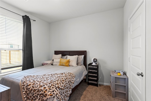 bedroom featuring dark colored carpet