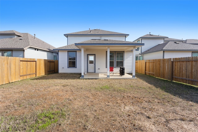 back of property featuring a patio area and a yard