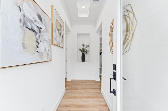 corridor with light wood-type flooring