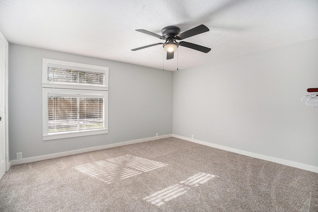 empty room featuring carpet flooring and ceiling fan