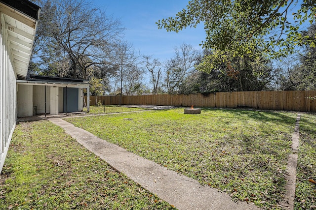 view of yard with a fire pit