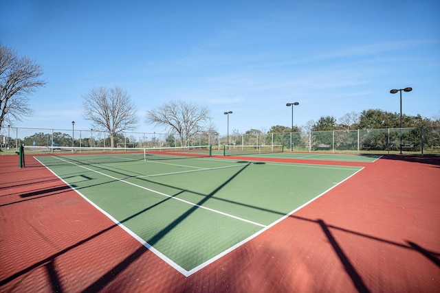 view of tennis court featuring basketball court